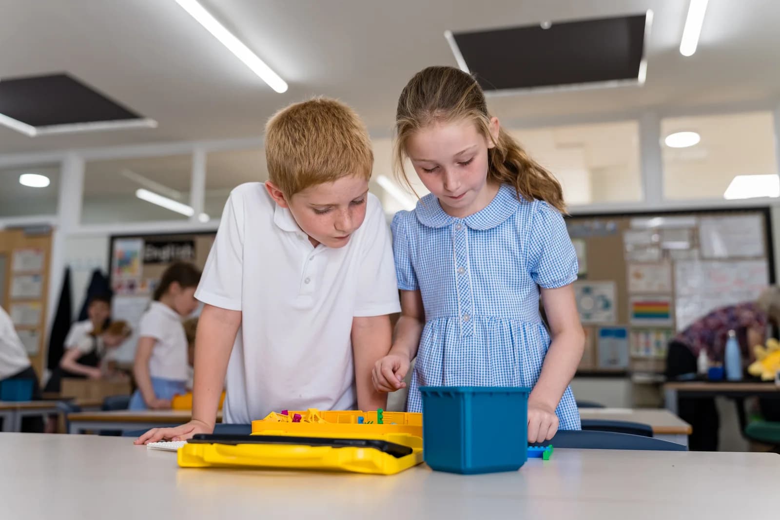 Children building and programming a LEGO robot together